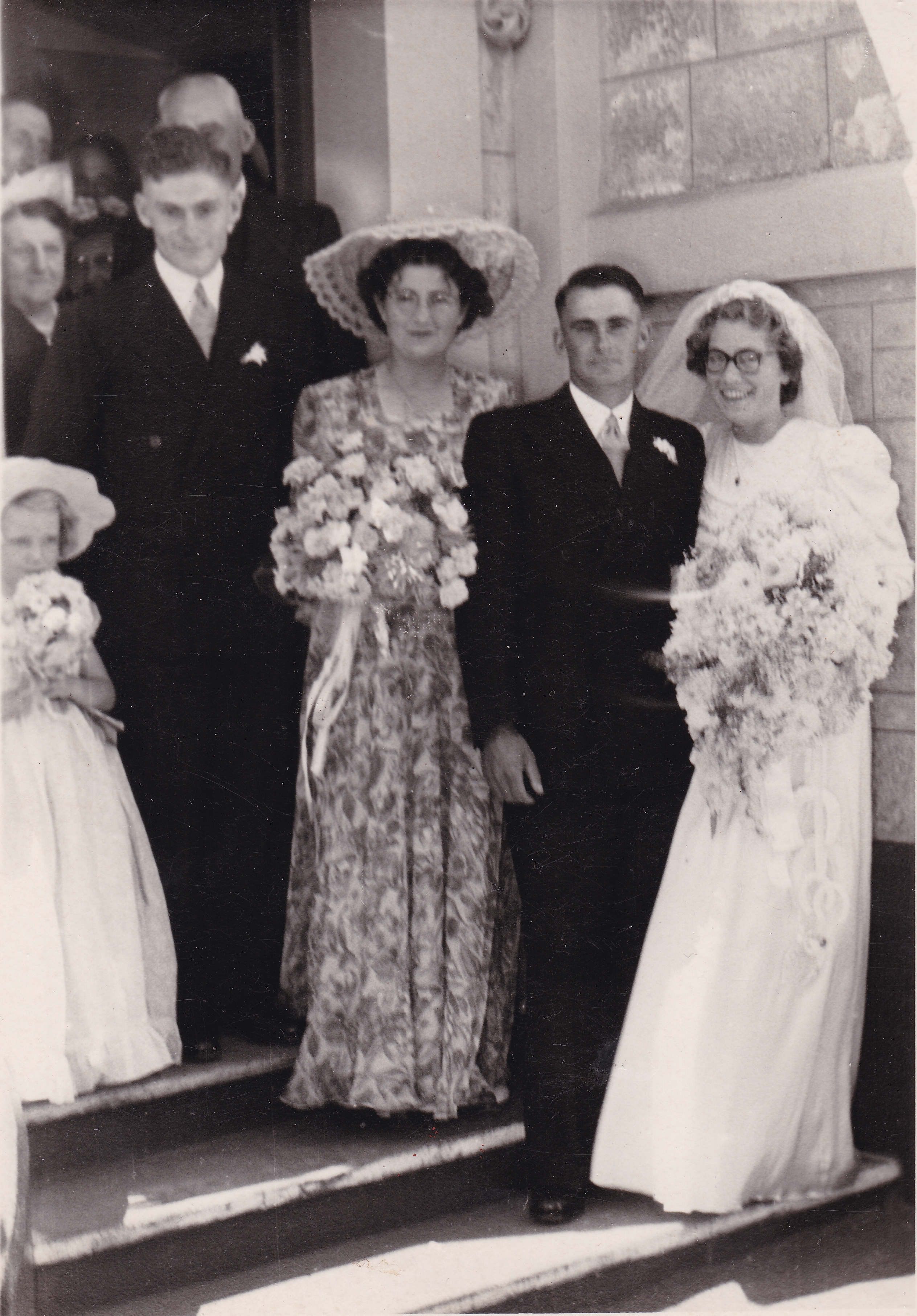 Wedding party outside the church building, 18 February 1950, Prospect Church of Christ, Adelaide — Murray and Shirley Telfer with attendants and guests on the church steps; prams and period cars in the background. Photograph supplied by their eldest son, Daryll William Telfer, 1 October 2026.